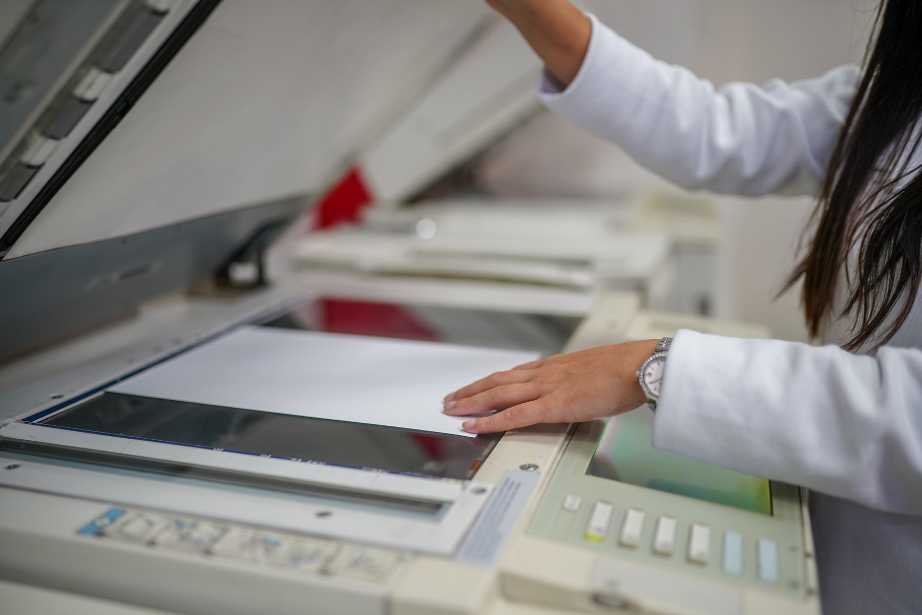 Woman copying document on copy machine